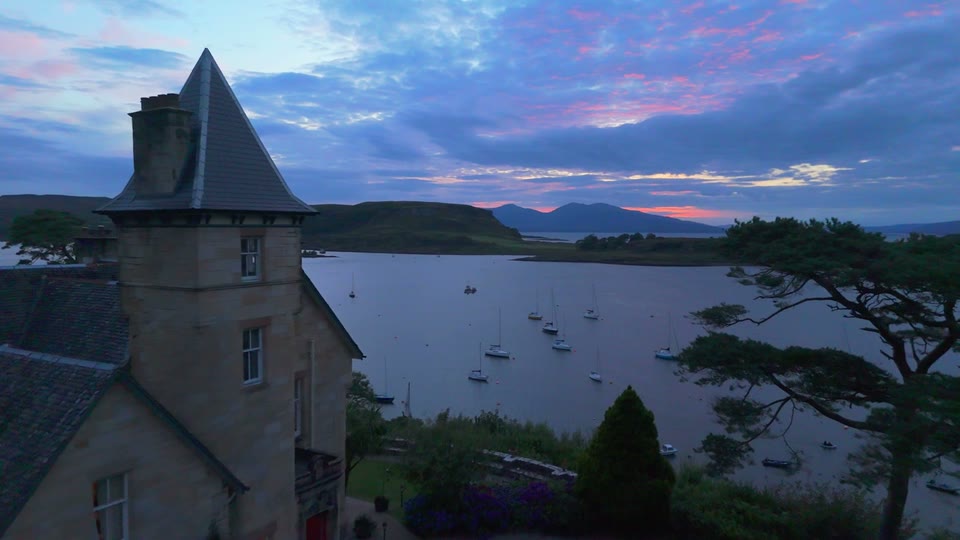 Sunset aerial drone footage of Dungallan House over Oban Bay